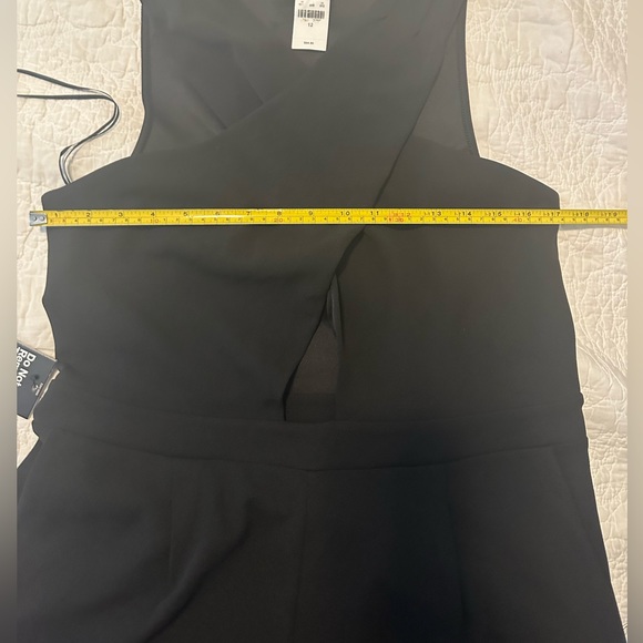 Express Black stretch jumpsuit. Low v neck front & opening below breast line. - Picture 2 of 9